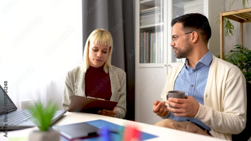 Portrait of young businesspeople working together in a home office. Couple of teamwork startup concept Portrait of young businesspeople working together in a home office. Couple of teamwork startup concept