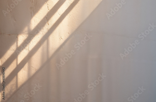 Sunlight through the window on the white wall. Abstract background.
