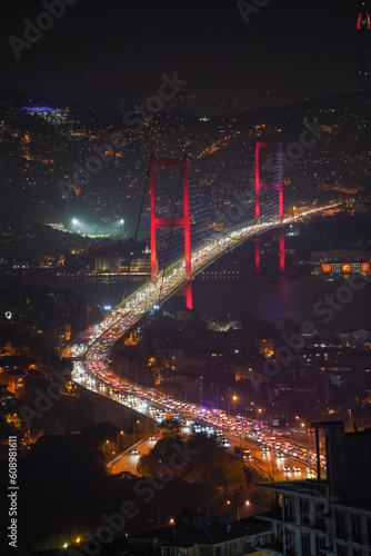 Bosphorus is illuminated at night and traffic is flowing
