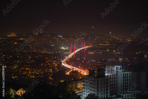 Bosphorus is illuminated at night and traffic is flowing