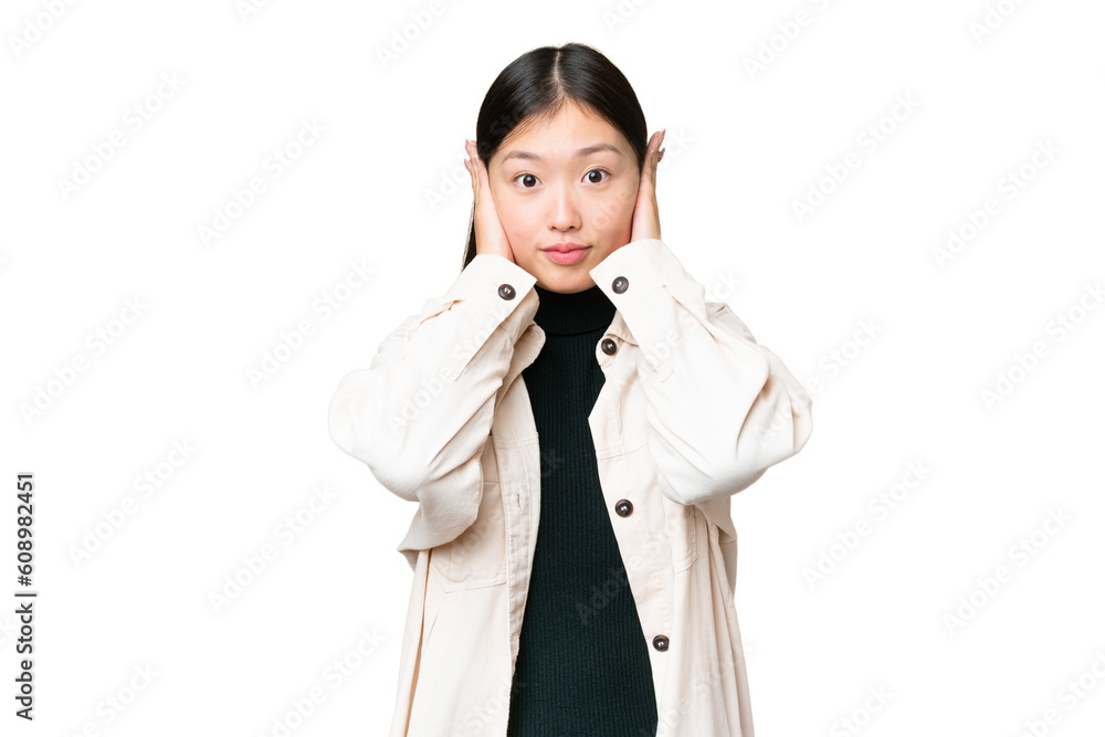 Young Asian woman over isolated chroma key background frustrated and covering ears Young Asian woman over isolated chroma key background frustrated and covering ears