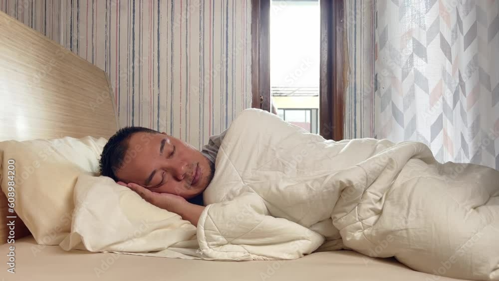 Man pulling blanket in the morning at the bedroom, time to wake up but still wanna sleep. Man pulling blanket in the morning at the bedroom, time to wake up but still wanna sleep.