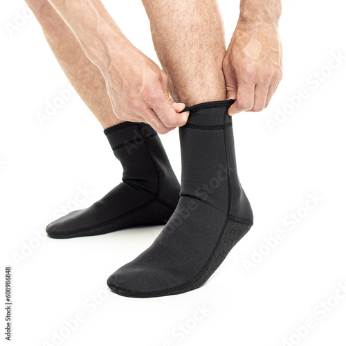 Φωτογραφία Man in neoprene socks for scuba diving on white background
