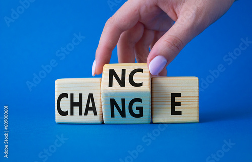 Build your brand symbol. Businessman hand turns wooden cubes with words Chance and Change. Beautiful blue background. Chance and Change and business concept. Copy space