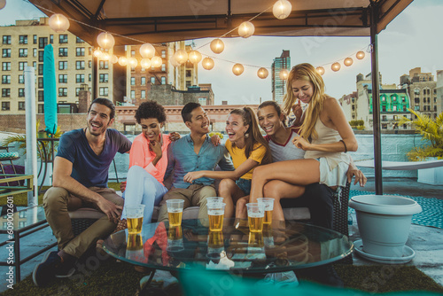 Canvas Print Multiethnic group of young happy friends bonding and having party at home on a r