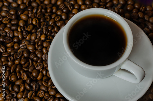 Coffee cup and coffee beans on table