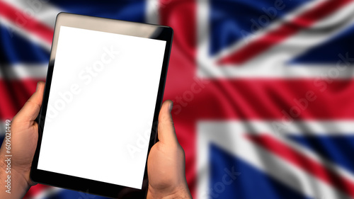 Man hold tablet phone pc gadget with white blank screen, copy space for text, image or message. Flag of United Kingdom country on background. Technology, information, business
