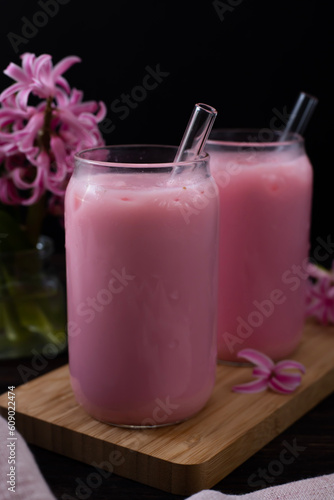 Strawberry milkshake and pink hyacinths on the table