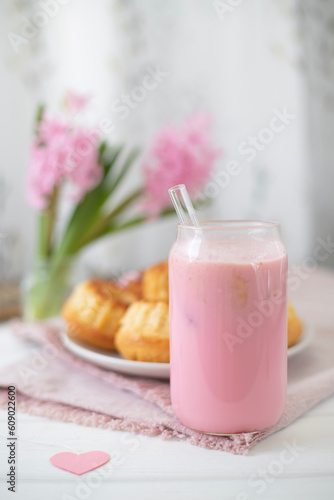 Strawberry milkshake, cakes and pink hyacinths