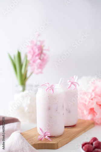 Two glasses with a cocktail of pink color with glass tubes