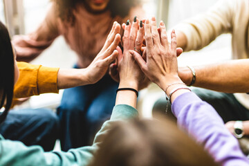 Young multiracial group stacking hands together- Happy diverse friends united at community table having fun- youth Millennial students giving strength motivation- Human resources teamwork  concept 