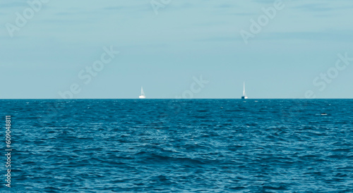in the middle of the sea with an infinite ocean with a perfect blue sky