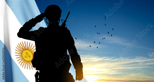 Silhouette of a saluting soldier with Argentina flag on background of sky. EPS10 vector