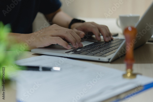 Businessman hands using laptop computer working online, searching Information tech data in internet and social media on desk.