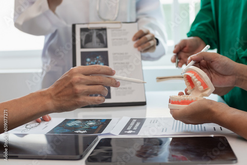 Konstfotografi team of dentists is diagnosing inside conference room treating patient toothache