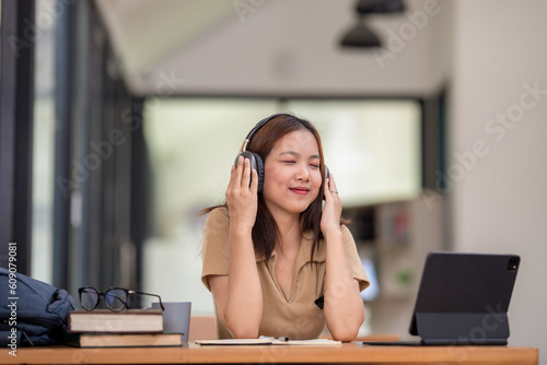 Female student take a break, listening music, relax from remote education and e-learning concept