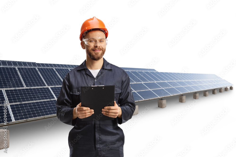 Technician in a uniform with a helmet and goggles holding a clipboard at a photovoltaic field Technician in a uniform with a helmet and goggles holding a clipboard at a photovoltaic field