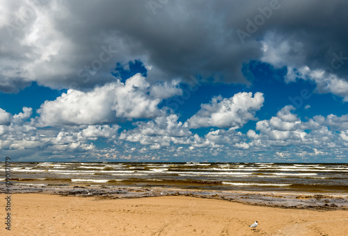 Coastal summer landscape with sandy beach and stormy weather with beautiful c...