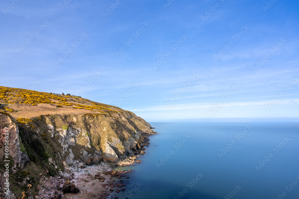 View of green heather fields, the Baily Lighthouse and the Irish Sea seen from the Howth Summit in Howth, near Dublin, Ireland