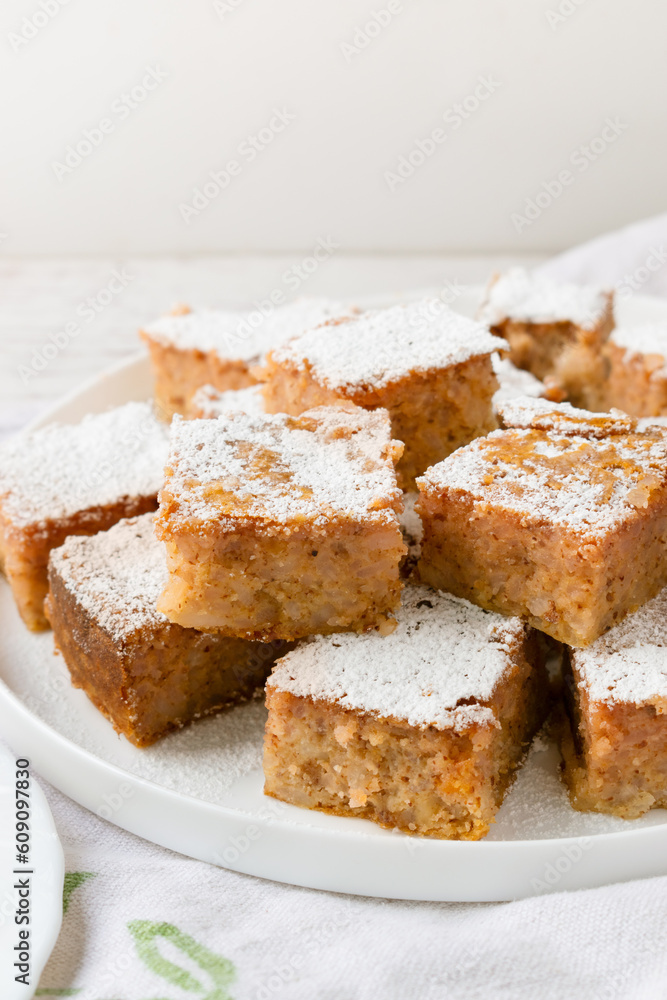 Traditional Bolognese rice cake cut into squares on a white background.