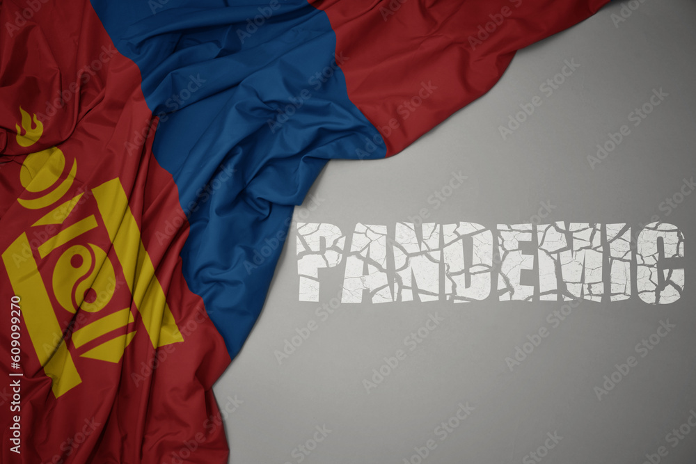 waving colorful national flag of mongolia on a gray background with broken text pandemic. concept.