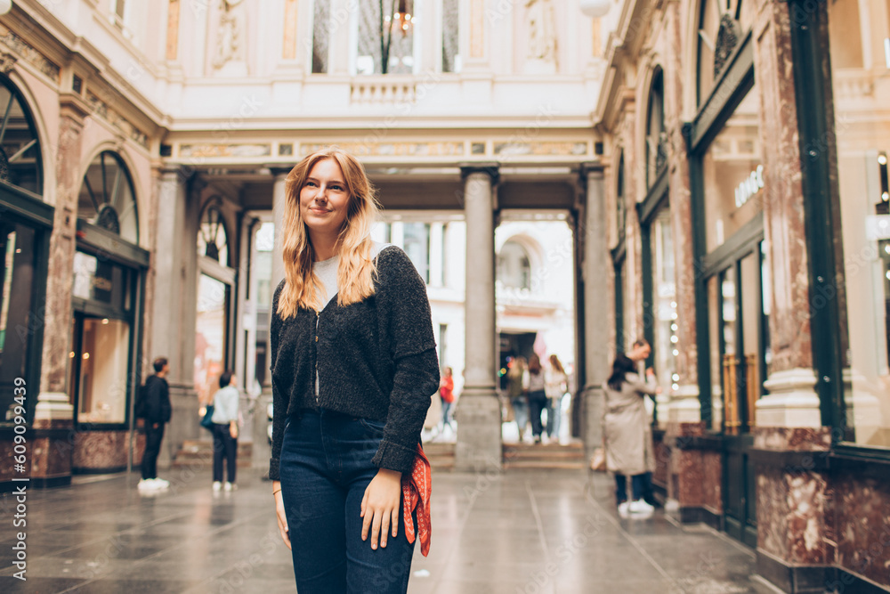 Fototapeta premium woman walking in old shopping area in europe
