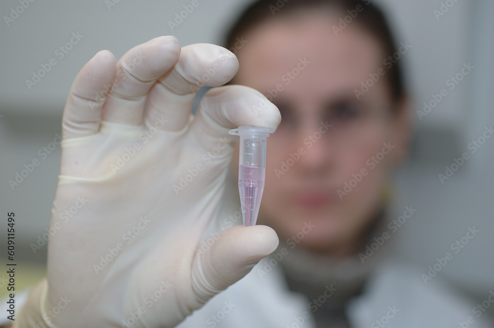 woman scientist holds flask in her hand woman scientist holds flask in her hand