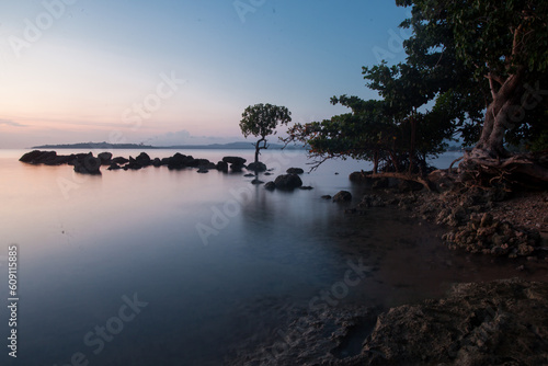sunset on the beach in morotai island photo