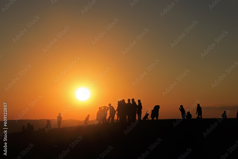 silhouette of people at sunset in desert
