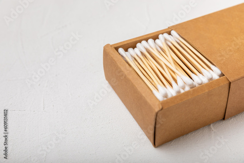 White cotton swabs on concrete texture background. Cotton buds. Bamboo cotton buds. Eco friendly. Hygienic cotton swabs for ears. Place for text. Place to copy.