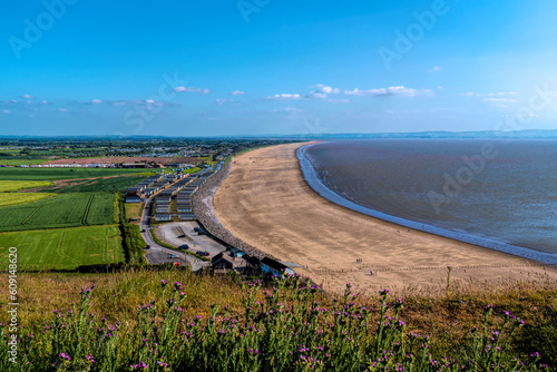 Brean sandy beach Somerset with pink flowers England UK tourist destination with blue sky photo