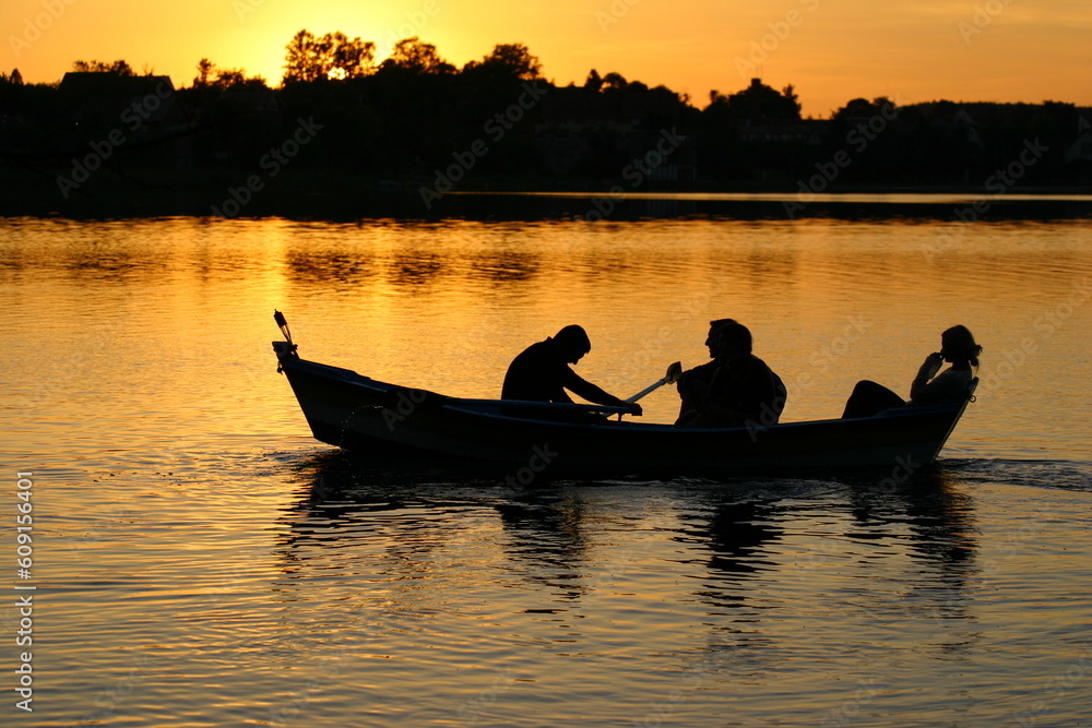 canoe with people in sunset