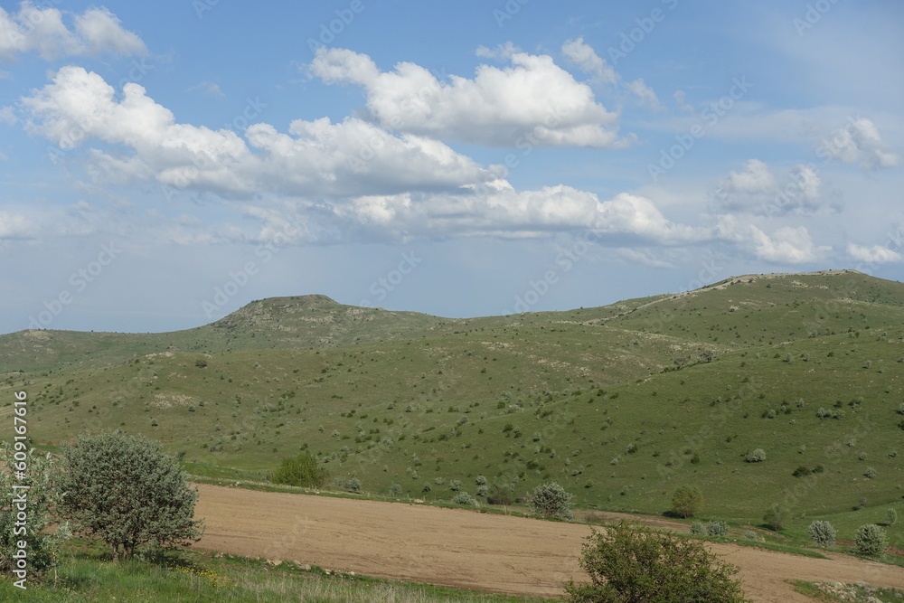 cloudy sky and green landscape, wonderful spring views, green field and hill plateau view,