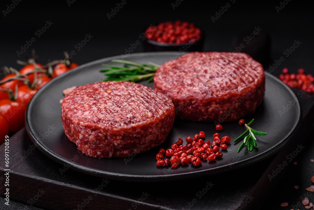 Fresh raw ground beef burger patty with salt and spices Fresh raw ground beef burger patty with salt and spices