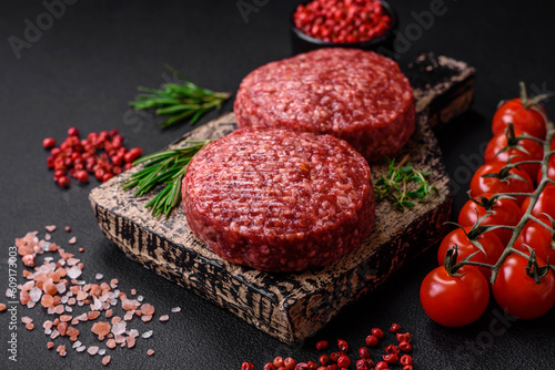 Fresh raw ground beef burger patty with salt and spices