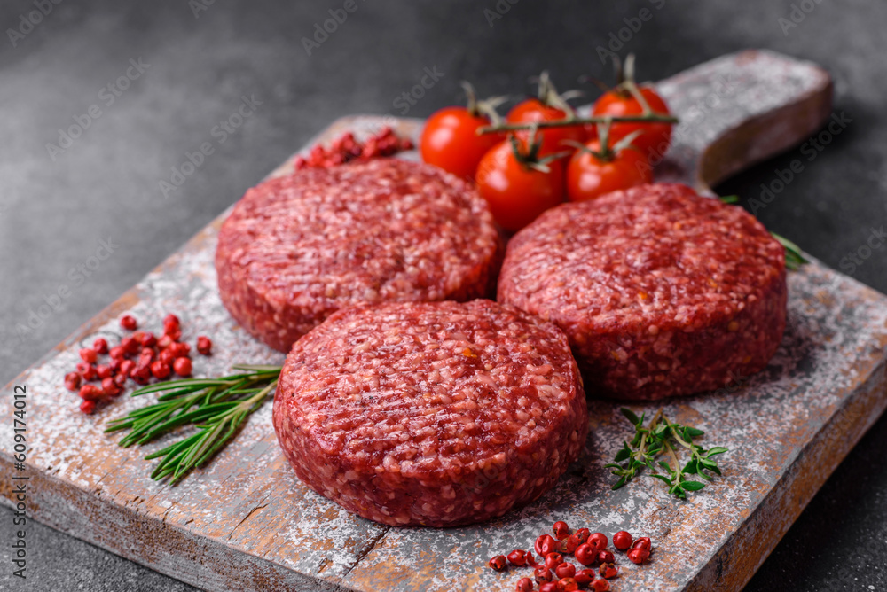Fresh raw ground beef burger patty with salt and spices Fresh raw ground beef burger patty with salt and spices