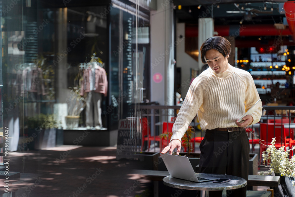 Portrait of asian man working using digital tablet and laptop at workplace. It specialist browsing