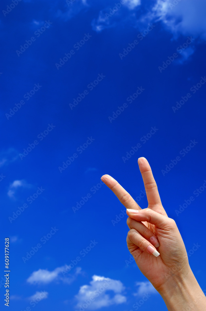 Victory sign with blue sky in the background Victory sign with blue sky in the background