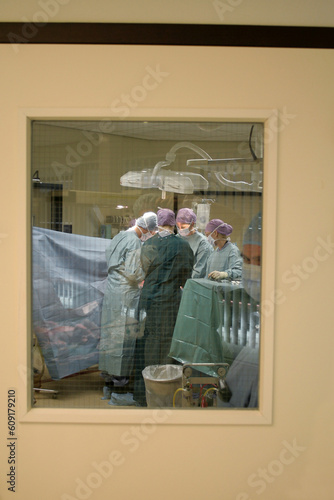 Docters/surgeons/mediacal personel at work in a surgeryroom photo