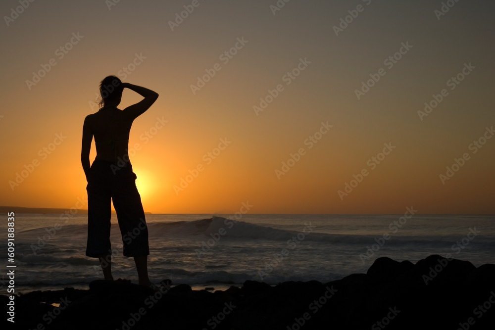Girl looks out to the future at La Santa beach in Lanzarote