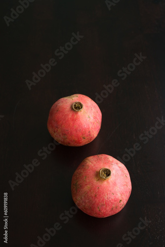 Pomegrantes ripped open with seeds exposed photo