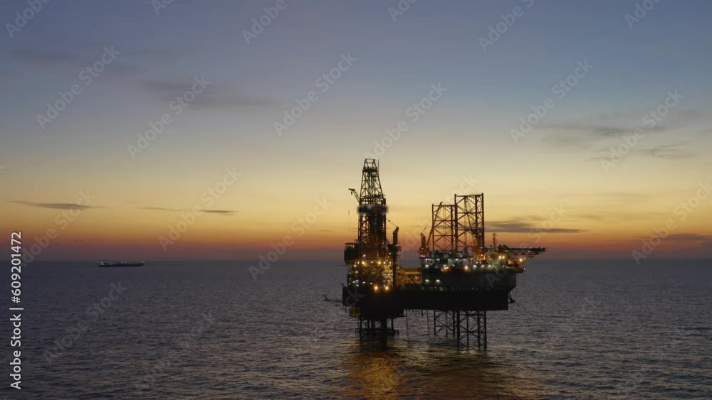Aerial view of offshore jack up drilling rig during early night time - oil and gas industry
Aerial view of offshore jack up drilling rig during early night time - oil and gas industry