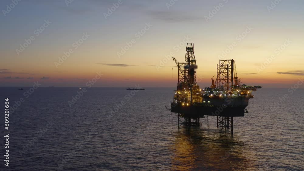 Aerial view of offshore jack up drilling rig during early night time - oil and gas industry
Aerial view of offshore jack up drilling rig during early night time - oil and gas industry