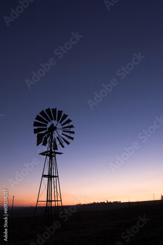 silhouette of a windmill at sunset