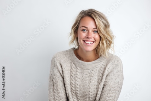 Portrait of a beautiful young blonde woman smiling on a white background