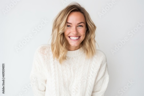 Portrait of a beautiful young woman smiling at camera over white background