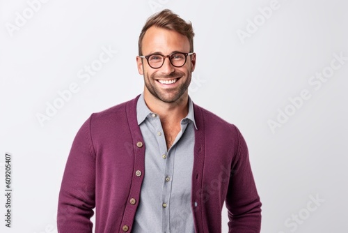 Portrait of a handsome young man in glasses standing against white background