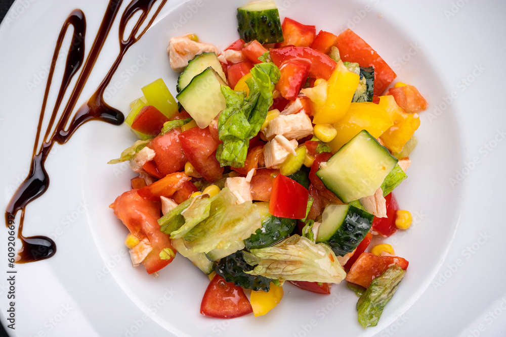 fresh vegetable and chicken fillet salad on a white plate fresh vegetable and chicken fillet salad on a white plate