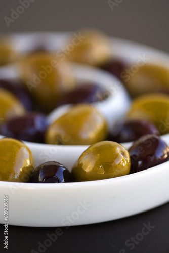 Green and Black olives in a sprial bowl photo