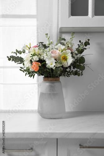 Bouquet of beautiful flowers on white countertop indoors